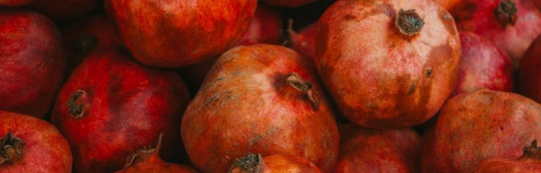 A large pile of bruised pomegranates.