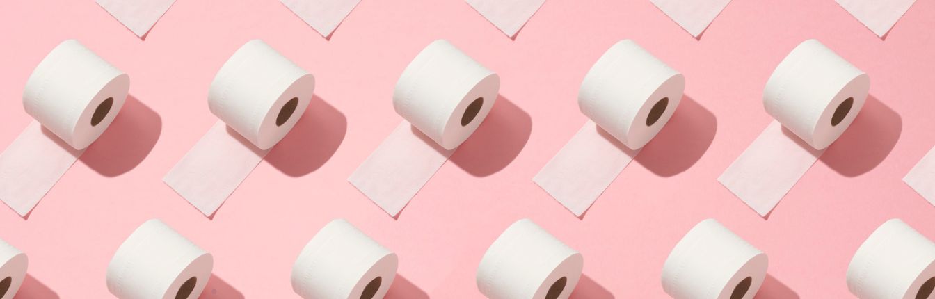 A digital image of rolls of toilet paper repeated on a pink background.